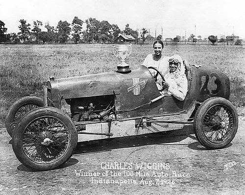 Charles Wiggins in his race car after winning the 100 Mile Auto Race, August 7, 1926