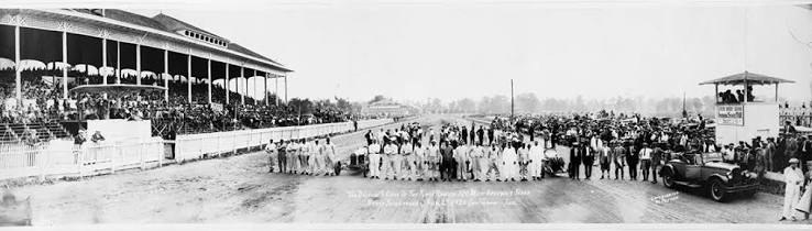 Drivers, officials and fans lined up in front of the grandstand at the Gold & Glory Sweepstakes