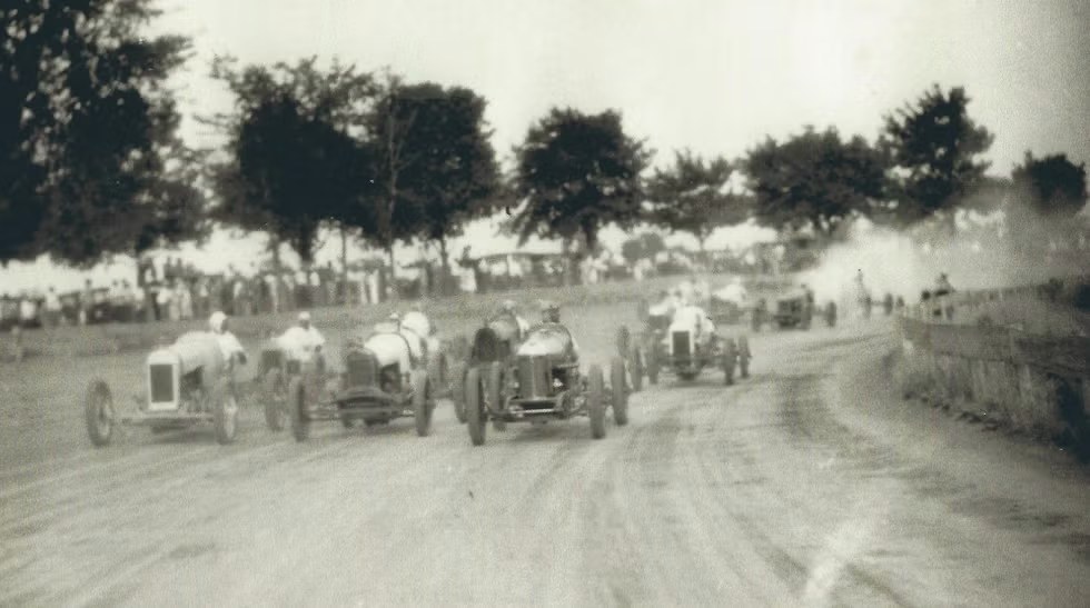 Race cars kicking up dirt at a Gold & Glory race at the Indiana State Fairgrounds