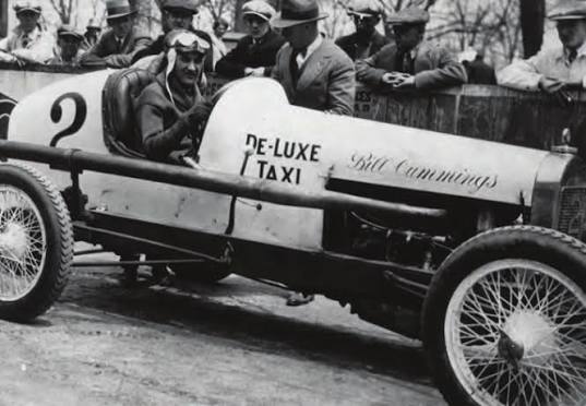 Bill Cummings in goggles at the wheel of his number 2 race car