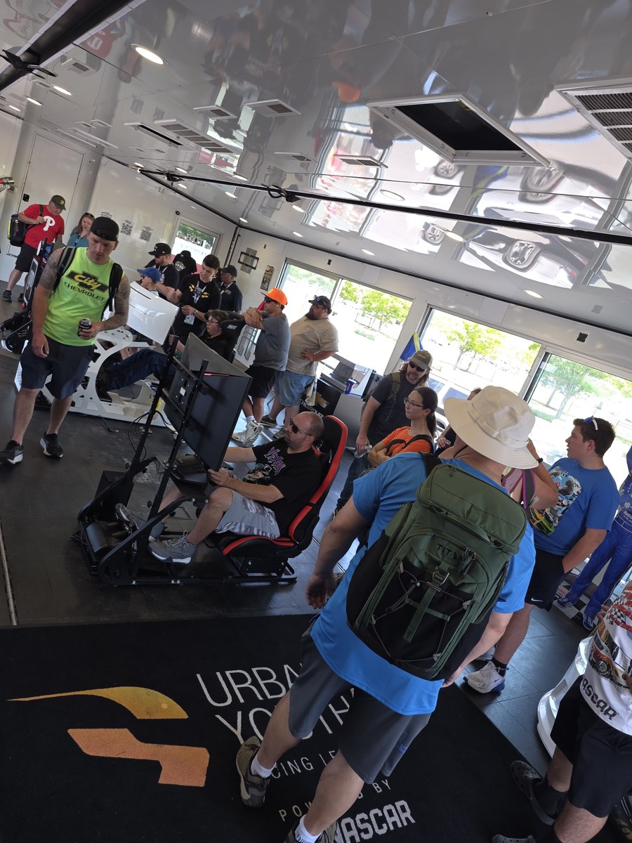 Visitors trying the racing simulators inside the UYRS STEM Truck